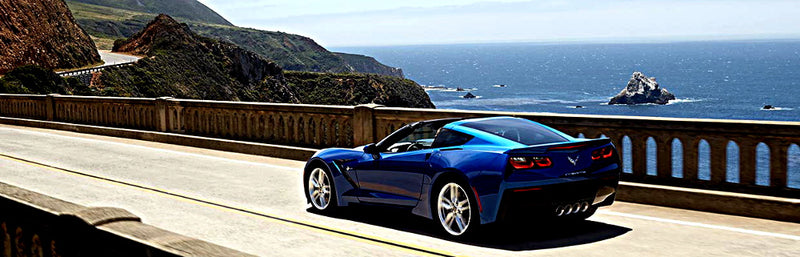 2015 blue Corvette Driving down the road