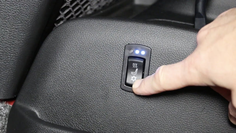 Degrees cooling switch on Seat side trim panel with finger pointing to it